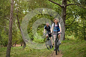 Healthy couple enjoying a bike ride in nature