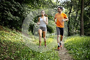 Healthy couple jogging in nature