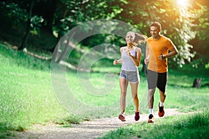 Healthy couple jogging in nature