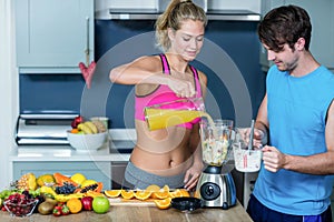 Healthy couple preparing a smoothie