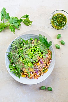 Healthy couscous salad with edamame beans, rucola and cucamelon photo