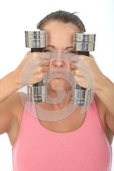 Healthy Crazy Young Woman Holding Dumb Bell Weights and Pulling Silly Facial Expression photo