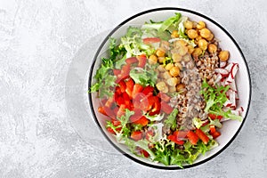 Healthy and delicious bowl with buckwheat and salad of chickpea, fresh pepper and lettuce leaves. Dietary balanced plant-based foo