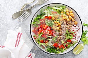 Healthy and delicious bowl with buckwheat and salad of chickpea, fresh pepper and lettuce leaves. Dietary balanced plant-based foo photo