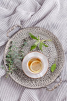 Healthy detox ginger and sage tea with lemon on tray