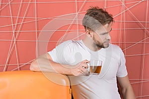 Healthy diet for cold or flue. Man hold cup of tea or coffee in kitchen. Macho at retro fridge on pink background