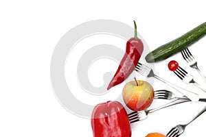 A healthy diet food. fresh cherry tomato, red pepper, cucumber, apple and orange fruits on forks on white background. Healthy