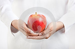 Healthy diet and lifestyle - person in white dress holding an ap