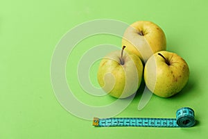 Healthy diet and low calorie food concept. Apples near tape