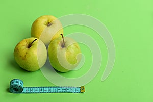 Healthy diet and low calorie food concept. Apples near tape