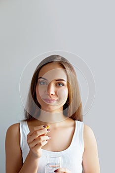 Healthy Diet Nutrition. Portrait Of Beautiful Smiling Young Woman Taking Vitamin Pill. Closeup Of Happy Girl Holding Colorful Caps