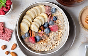 Healthy diet. Oatmeal. Ingredients for porridge. Wholesome breakfast. Delicious summer berries. Useful nuts.