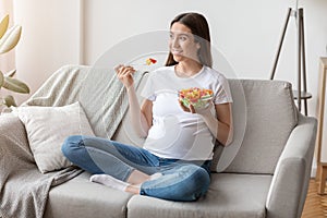 Healthy Diet During Pregnancy. Young expectant woman enjoying fresh vegetable salad