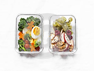 Healthy diet snack, breakfast lunch box on light background, top view. Boiled egg, fresh vegetables and fruits - tasty healthy