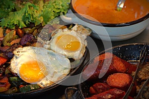 Healthy diet - stewed veggies and fried eggs nicely arranged on a table