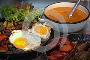 Healthy diet - stewed veggies and fried eggs nicely arranged on a table