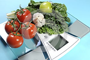 Healthy diet and weight loss concept with healthy vegetables and diet scale.