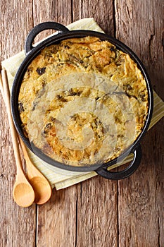 Healthy dietary English food Bubble & Squeak from baked mashed potatoes with cabbage and Brussels sprouts in a pan on the table.