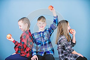 Healthy dieting and vitamin nutrition. Boy and girls friends eat apple snack while relaxing. School snack concept. Group