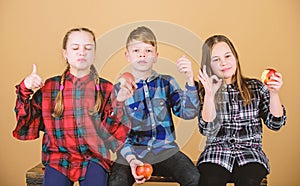 Healthy dieting and vitamin nutrition. Boy and girls friends eat apple snack while relaxing. School snack concept. Teens