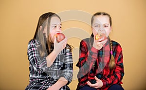 Healthy dieting and vitamin nutrition. Girls friends eat apple snack while relaxing. School snack concept. Teens with