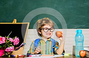 Healthy dinner or breakfast in school. Little child boy from elementary school eating apple having lunch break. Primary