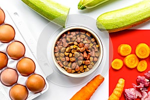 Healthy dogfood with eggs, vegetables and meat on kitchen background top view photo