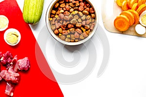 healthy dogfood with eggs, vegetables and meat on kitchen top view mockup