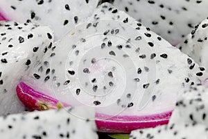 Healthy dragon fruit or pitaya pieces background, close up of beautiful fresh sliced dragon fruit with texture in the market in