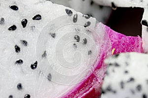 Healthy dragon fruit or pitaya pieces background, close up of beautiful fresh sliced dragon fruit with texture in the market in