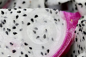 Healthy dragon fruit or pitaya pieces background, close up of beautiful fresh sliced dragon fruit with texture in the market in