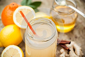 Healthy drink made of lemon, cinammon, ginger and honey photo