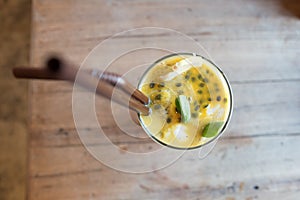 Healthy drinks, passion fruit mix with plain yogurt decorated with lemon and green leaf.