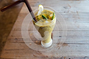 Healthy drinks, passion fruit mix with plain yogurt decorated with lemon and green leaf.