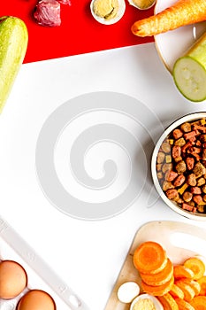 healthy dry dogfood with ingredients on table top view mock up