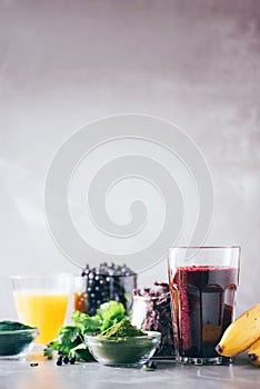 Healthy eating, alkaline diet, vegan concept. Blueberries, bilberry, barley grass juice, spirulina, orange juice, dulse and