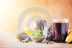 Healthy eating, alkaline diet, vegan concept. Blueberries, bilberry, barley grass, spirulina powder, orange juice, dulse, cilantro