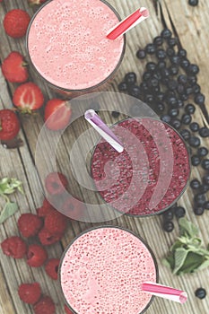 Appetizing smoothies and detox drinks from ripe berries. Raspberries, strawberries, blueberries. Healthy eating.