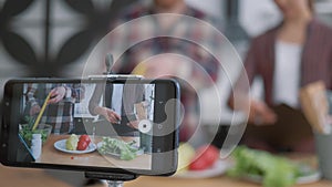 Healthy eating blog, mobile phone makes video recording live how bloggers man and woman cook preparing healthy meals
