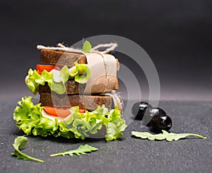 Healthy eating breakfast concept, food background. Closeup of vegetarian sandwich on slate board.