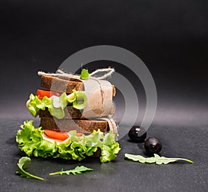 Healthy eating breakfast concept, food background. Closeup of vegetarian sandwich on slate board.