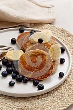 Healthy eating concept. Banana oatmeal pancakes served with blue