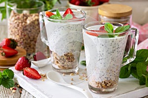 Healthy eating concept breakfast. Strawberry parfait with yogurt, chia seeds, homemade granola and fresh berries.