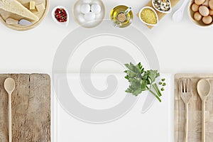 Healthy eating concept with cutting boards and cooking ingredients on kitchen white worktop, copy space, top view