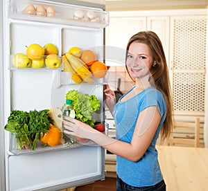 Healthy Eating Concept. Diet. Young Woman near the Refrigerator