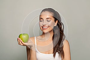 Healthy eating concept. Perfect brunette woman with a green apple