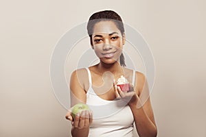 Healthy eating concept. Pretty woman with fruit and cake portrait