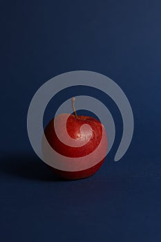 Healthy eating concept - red apple isolated on blue background