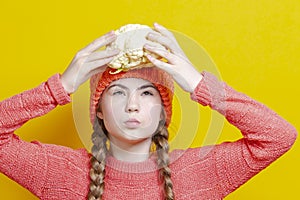 Healthy Eating Concepts. Thinking Caucasian Girl In Coral Knitted Clothing Posing With Cauliflower as a Demonstration of Human