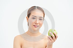 Healthy eating, diet and people concept - smiling young woman with green apple at home